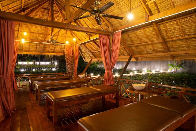 Wooden massage pavilion lit in the evening