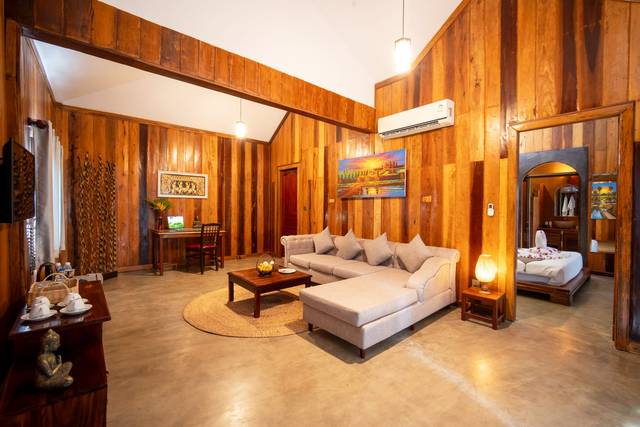 Pool villa living room in warm wood